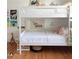 room with a fun, bunk bed featuring white rails and a 