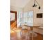 Bright dining area featuring a round table, bench seating, and natural light from adjacent windows and wood door at 207 N Aiken St, Fuquay Varina, NC 27526