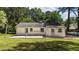 Rear view of home features a gravel area, siding, and a well-manicured lawn at 207 N Aiken St, Fuquay Varina, NC 27526