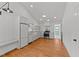 Bright kitchen with hardwood floors, marble countertops, and stainless steel appliances at 207 N Aiken St, Fuquay Varina, NC 27526