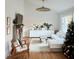 Cozy living room decor with hardwood floors, a Christmas tree, and an area rug at 207 N Aiken St, Fuquay Varina, NC 27526
