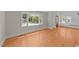 Living room featuring hardwood floors, large window, and bright natural light at 207 N Aiken St, Fuquay Varina, NC 27526