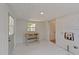 Interior space with a window, painted brick, and a light fixture, offering a bright and airy atmosphere at 207 N Aiken St, Fuquay Varina, NC 27526