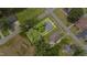 Aerial view of a home with a lush, green yard, mature trees, and a defined property line at 208 S College Ave, Kenly, NC 27542