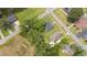 Aerial view of a neighborhood featuring the property with mature trees and green lawns at 208 S College Ave, Kenly, NC 27542