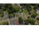 Overhead angle of a home on a corner lot with a green lawn, driveway and established trees at 208 S College Ave, Kenly, NC 27542