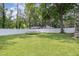 Grassy backyard enclosed by a white fence at 208 S College Ave, Kenly, NC 27542
