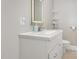 Bathroom with a white vanity, sleek sink, illuminated mirror, and open shelving at 208 S College Ave, Kenly, NC 27542