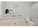 Bright bathroom featuring a vanity and sink with a large mirror, along with a toilet at 208 S College Ave, Kenly, NC 27542