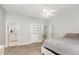 Spacious bedroom featuring a ceiling fan and multiple doors with a view into the bathroom at 208 S College Ave, Kenly, NC 27542