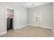 Empty bedroom with carpeted floor, closet, and window with blinds, ready to be furnished at 208 S College Ave, Kenly, NC 27542