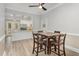 Dining area connects to the kitchen, featuring a wooden table with seating and bright, airy ambiance at 208 S College Ave, Kenly, NC 27542