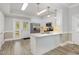 Modern kitchen featuring stainless steel appliances, granite countertops, white cabinets, and a stylish breakfast bar at 208 S College Ave, Kenly, NC 27542