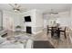 Open-concept living space with fireplace, TV, modern flooring, and seamless transition to the dining area at 208 S College Ave, Kenly, NC 27542