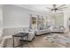Bright living room features modern furniture, stylish decor, large windows, and a ceiling fan for added comfort at 208 S College Ave, Kenly, NC 27542