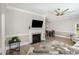 Cozy living space includes a fireplace with mounted TV, wood floors, open access to dining area and lots of natural light at 208 S College Ave, Kenly, NC 27542