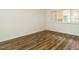 Bedroom with hardwood floors, white walls, and a window at 2316 Champion Ct, Raleigh, NC 27606