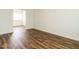 Bedroom with hardwood floors, white walls, and a window at 2316 Champion Ct, Raleigh, NC 27606