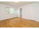 Neutral bedroom with hardwood flooring, a window and white door at 2316 Champion Ct, Raleigh, NC 27606
