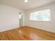 Bedroom with hardwood floors and a large window for plenty of natural light at 2316 Champion Ct, Raleigh, NC 27606