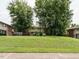 Well-manicured lawn with shade trees and a swing at 2316 Champion Ct, Raleigh, NC 27606