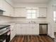 Updated kitchen with white cabinets, stainless steel dishwasher and new countertops at 2316 Champion Ct, Raleigh, NC 27606