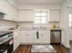 Updated kitchen with white cabinets, stainless steel dishwasher and new countertops at 2316 Champion Ct, Raleigh, NC 27606