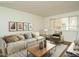 Staged living room with couch, chair, table, and window at 2316 Champion Ct, Raleigh, NC 27606