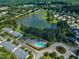 Aerial view of community featuring a pond, swimming pool, roundabout and meticulously landscaped grounds at 240 Meadow Beauty Dr, Apex, NC 27539
