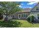 Well-kept backyard features a brick patio, grassy area, and an attractive neutral siding home at 240 Meadow Beauty Dr, Apex, NC 27539