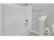 Clean, bright white bathtub with shower and grey walls in this bathroom at 240 Meadow Beauty Dr, Apex, NC 27539