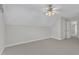 Spacious carpeted bedroom features a ceiling fan and hallway views at 240 Meadow Beauty Dr, Apex, NC 27539