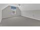 Spacious carpeted bedroom with a vaulted ceiling features a ceiling fan and window at 240 Meadow Beauty Dr, Apex, NC 27539
