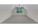 Carpeted bedroom with vaulted ceiling features a ceiling fan and window views at 240 Meadow Beauty Dr, Apex, NC 27539