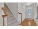 Inviting foyer with hardwood floors, staircase, and a decorative front door providing natural light at 240 Meadow Beauty Dr, Apex, NC 27539
