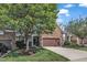 Beautiful townhome exterior featuring a stone facade, garage, and a well-maintained lawn at 240 Meadow Beauty Dr, Apex, NC 27539