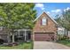 Charming townhome exterior with a stone facade, lush lawn, and a well-manicured front yard at 240 Meadow Beauty Dr, Apex, NC 27539