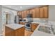 Well-lit kitchen featuring stainless steel appliances, wood cabinets, and quartz countertops at 240 Meadow Beauty Dr, Apex, NC 27539