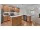 Charming kitchen with stainless steel appliances, wood cabinets, and a central island at 240 Meadow Beauty Dr, Apex, NC 27539