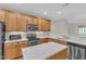 Bright kitchen featuring stainless steel appliances, a center island and wooden cabinetry at 240 Meadow Beauty Dr, Apex, NC 27539