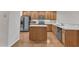 Spacious kitchen featuring stainless steel appliances, wooden cabinetry, and a center island at 240 Meadow Beauty Dr, Apex, NC 27539