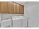 Well-equipped laundry room featuring a utility sink and matching washer and dryer units at 240 Meadow Beauty Dr, Apex, NC 27539