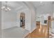 Open-concept living space with hardwood floors, fireplace, and views into dining and kitchen at 240 Meadow Beauty Dr, Apex, NC 27539