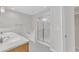 Light-filled main bathroom featuring double sinks, a separate bathtub, and a glass-enclosed shower at 240 Meadow Beauty Dr, Apex, NC 27539