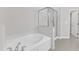 A close up of the separate jetted bathtub and glass shower in the main bathroom at 240 Meadow Beauty Dr, Apex, NC 27539