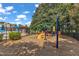 Outdoor playground with modern equipment next to the community pool at 240 Meadow Beauty Dr, Apex, NC 27539