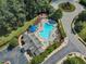 Aerial view of the neighborhood pool, playground, and roundabout in the neighborhood at 240 Meadow Beauty Dr, Apex, NC 27539