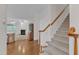 Inviting staircase featuring carpeted steps, wood railing, and natural light at 240 Meadow Beauty Dr, Apex, NC 27539