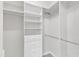 Bright walk-in closet includes shelving, drawers, and rods for optimal organization at 240 Meadow Beauty Dr, Apex, NC 27539
