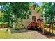 Exterior view of home with a wooden deck and staircase, complemented by a lush green lawn at 2501 Springfield Park Dr, Raleigh, NC 27614